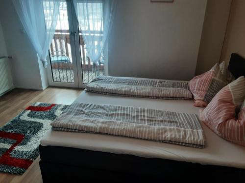 three beds in a room with a balcony at Apartment - Ferienwohnung 2 Treffen am Ossiachersee in Treffen
