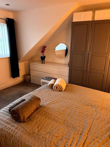 a bedroom with a bed with towels on it at The Hideaway Southport in Southport
