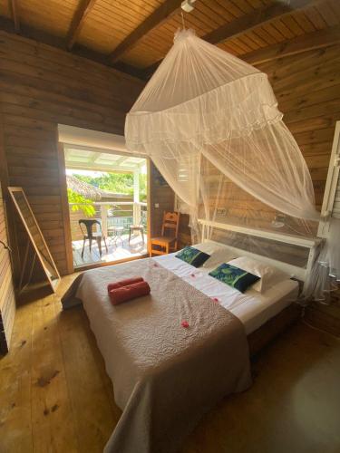 a bedroom with a large bed with a mosquito net at Villa Titi in Saint-François