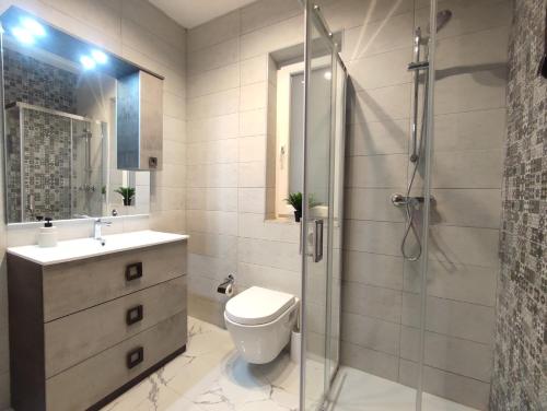 een badkamer met een toilet en een glazen douche bij Sliema Central 3 Bedroom Apartment Near Seafront in Sliema
