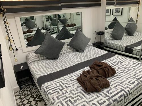 a bedroom with two beds and a large mirror at Yumboparadise in Playa del Ingles