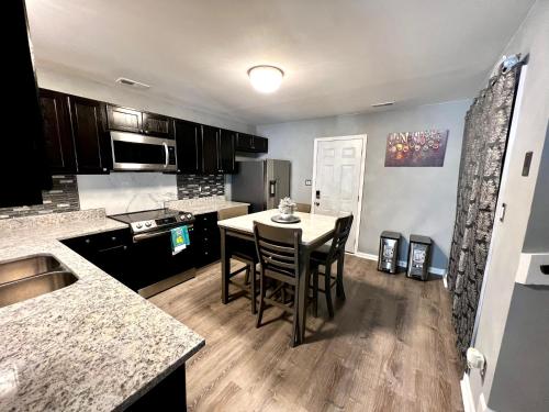 a kitchen with a table and chairs in a room at Luxury Townhome Jacksonville, NC in Jacksonville