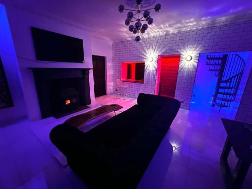 a living room with a couch and a fireplace at Lower Winsford Apartments & Rooms in Bideford
