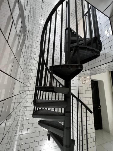 a black spiral staircase in a building at Lower Winsford Apartments & Rooms in Bideford