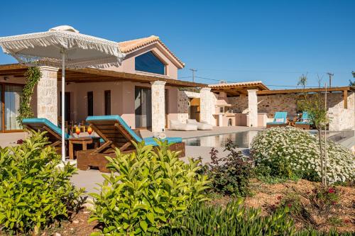 a villa with a swimming pool and a house at Terra Lucis Mountain Residences in Agios Leon