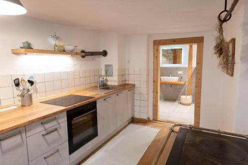 a kitchen with a sink and a counter top at Landhaus im Allgäu in Halblech