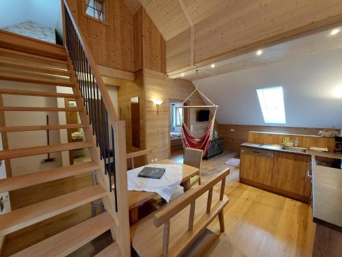 a room with a staircase and a kitchen with a laptop on a table at Seyerlehnerhof in Maria Neustift