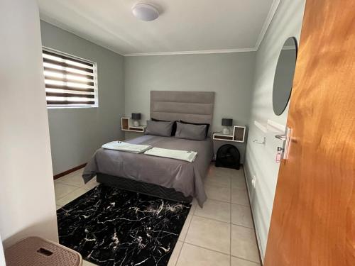 a bedroom with a bed in a room at 1One1@Boneyard in Jeffreys Bay