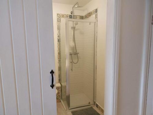 a shower in a bathroom with a glass shower stall at JESMOND House B&B room 4 in Hull