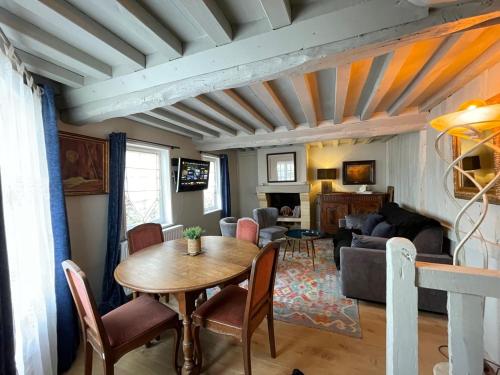 een woonkamer met een tafel en stoelen bij La maison St Jean in Honfleur