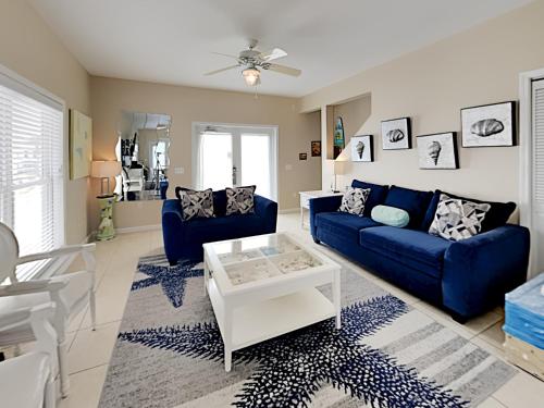 a living room with a blue couch and a table at La Favorita in Navarre