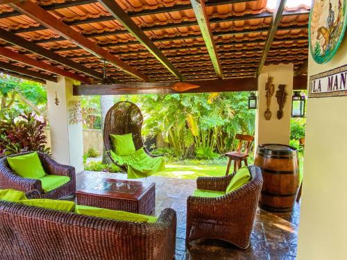 a patio with chairs and a table and a barrel at La Mancha in Southbroom