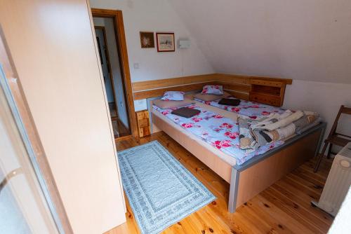 a bedroom with a bed and a blue rug at Spectacular LakeView House in Žabljak