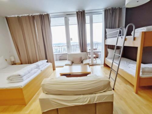 a bedroom with two bunk beds and a balcony at Villa Mari I in Maribor