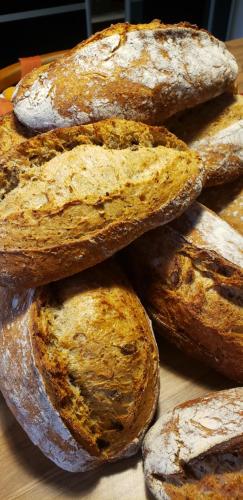 a pile of bread sitting on top of a table at B&B La Ferme de Loubens in Loubens-Lauragais