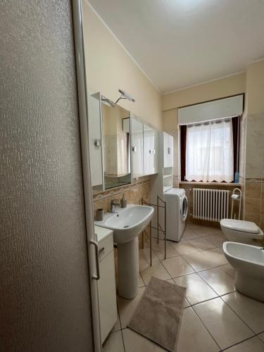 bagno con lavandino, servizi igienici e specchio di L'AQUILA 99 HOME a L'Aquila