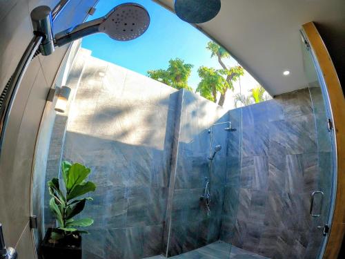 a shower with a glass door in a bathroom at Isan Golf & Adventure Hotel in Udon Thani