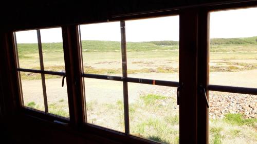 a view of a field from a window at Stundarfriður cottages in Stykkishólmur