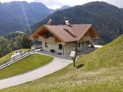 a house on the side of a hill at Appartamento l’ Aier - Arabba - Dolomiti in Livinallongo del Col di Lana