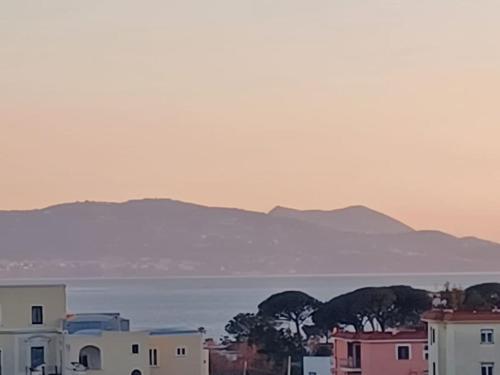a city with houses and the ocean and mountains at MiraCapri Home - the strategic centre between Napoli and Sorrento in Torre del Greco