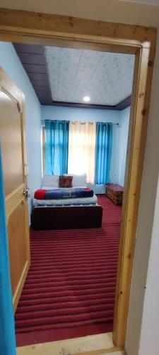 a view of a room with two beds in it at Nakpo Homestay in Leh