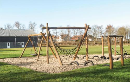 a playground with a swing set in a park at Stunning Home In Tranekær in Tranekær