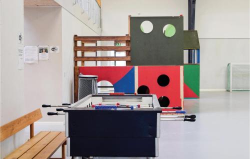 a ping pong table in an art room with a bench at Stunning Home In Tranekær in Tranekær