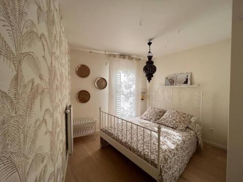 a bedroom with a bed and a large window at Superbe Appartement 3 pièces près de la Défense in Nanterre