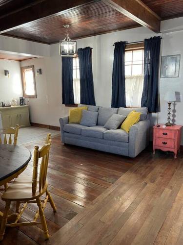 a living room with a couch and a table at Hanna’s Cottage-Downtown Hermann in Hermann