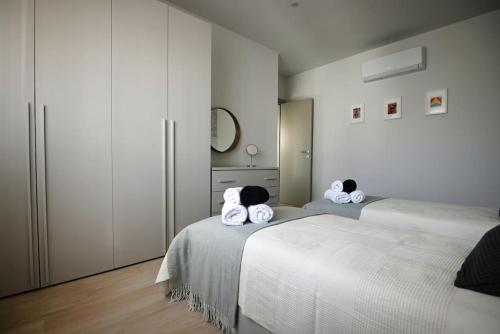 a bedroom with two beds with towels on them at Cliff Edge Apartment in Xaghra in Taʼ Bullara