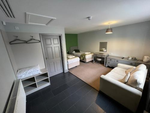 a living room with a couch and a bedroom at The Black Horse Inn in Gainsborough