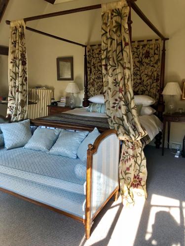 a bedroom with a bed with a canopy at B&B Harlington Manor in Harlington