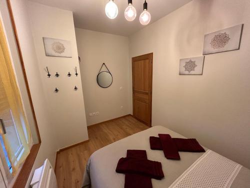 a bedroom with a bed with red crosses on it at Champagne & Grand Cru in Ay