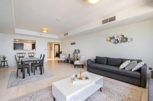 a living room with a couch and a table at Balqis Residense Palm Jumeirah,Pool, Beach, Top floor, Full sea view, Restaurants in Dubai