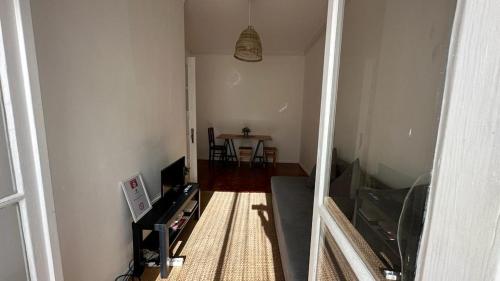 a room with a hallway with a table and a room with a hallway at Coral Apartment in Lisbon