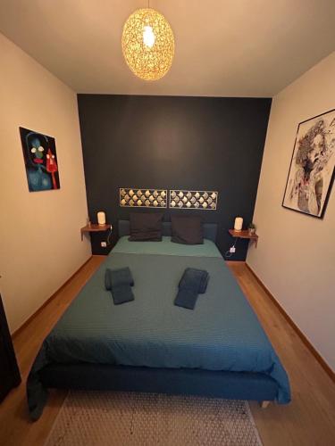 a bedroom with a large bed with a blue blanket at Champagne & Grand Cru in Ay