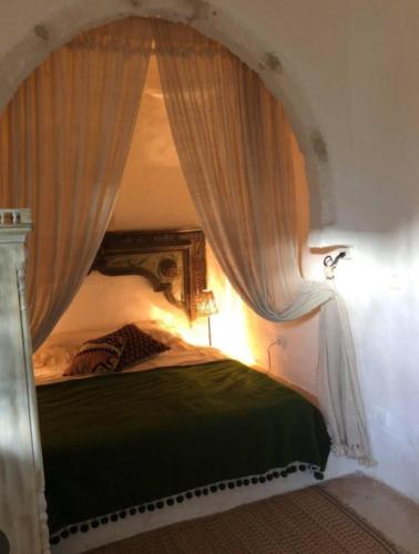 a bedroom with a bed with a canopy at Dar zmen in Tunis