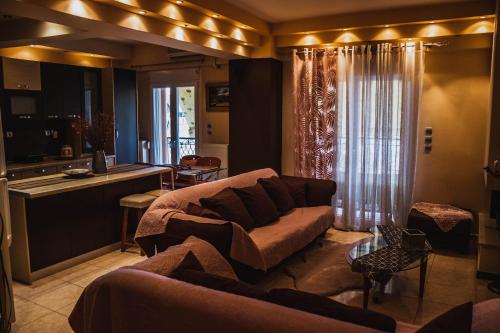 a living room with a couch and a kitchen at Bojana' s luxury house in Larisa