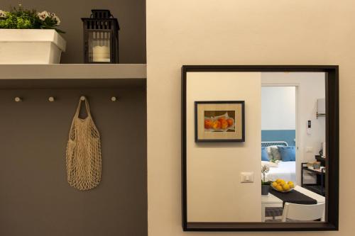a mirror on a wall next to a room at Suite Apartments - Corso51 in Rimini