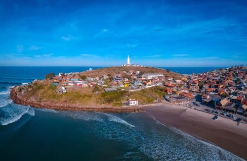 an island in the ocean with a lighthouse on it at Casas da Dalma in Farol de Santa Marta