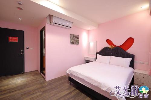 a bedroom with a white bed with a red headboard at Amir B&B train station & elevator with parking lot in Hualien City