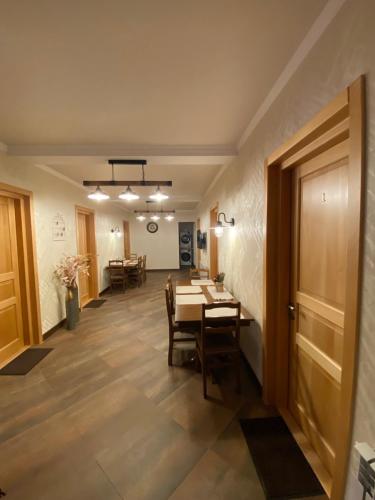 a dining room with a table and some chairs at Guesthouse SHAMPRIANI in Mestia