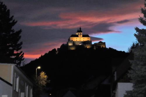 a building on top of a mountain at night at Appartement ROSalia in Forchtenstein
