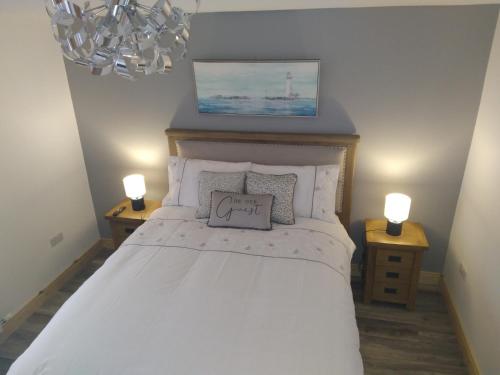 a bedroom with a white bed with two night stands at The Dingle Galley in Dingle