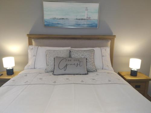 a bed with a pillow that says im our guest at The Dingle Galley in Dingle