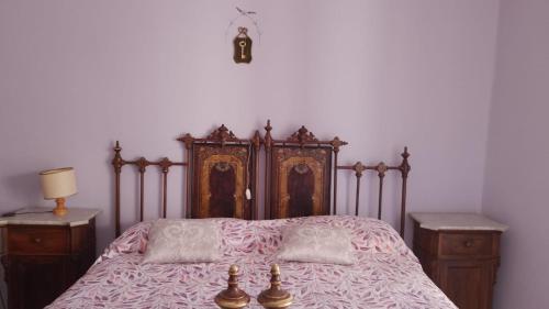 a bedroom with a large bed with a wooden headboard at Majella National Park La Casa Di Nonna Maria in Caramanico Terme