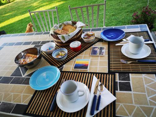 a table with plates and bowls of food on it at Il canto dell'asino in Gubbio