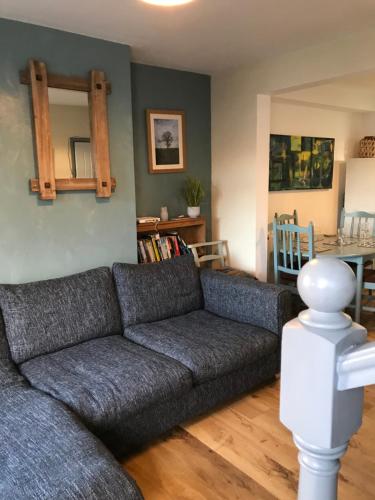 a living room with a couch and a table at Cosy 3 bedroom house close to beach in Lowestoft