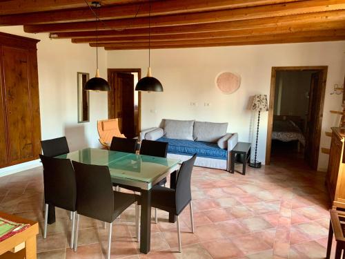 a living room with a table and a blue couch at Agriturismo Cervano in Toscolano Maderno