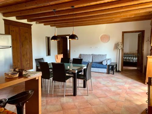 a dining room and living room with a table and chairs at Agriturismo Cervano in Toscolano Maderno